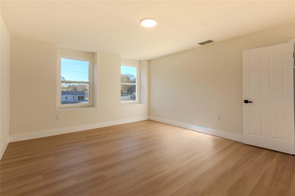 3324 Haystack Road Wesley Chapel, FL 33543 - Photo 58 of 91 a view of an empty room with wooden floor and a window