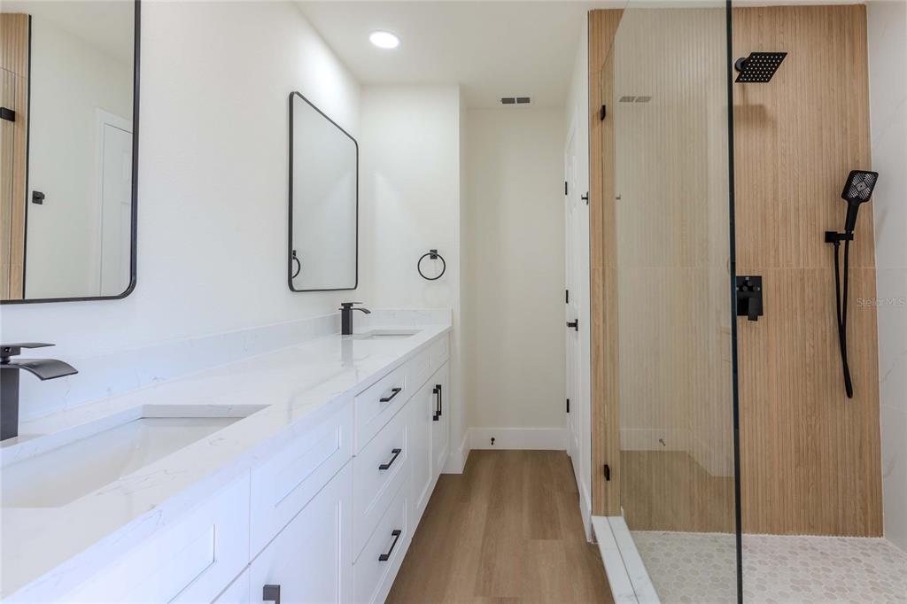3324 Haystack Road Wesley Chapel, FL 33543 - Photo 61 of 91 a bathroom with a double vanity sink mirror and shower