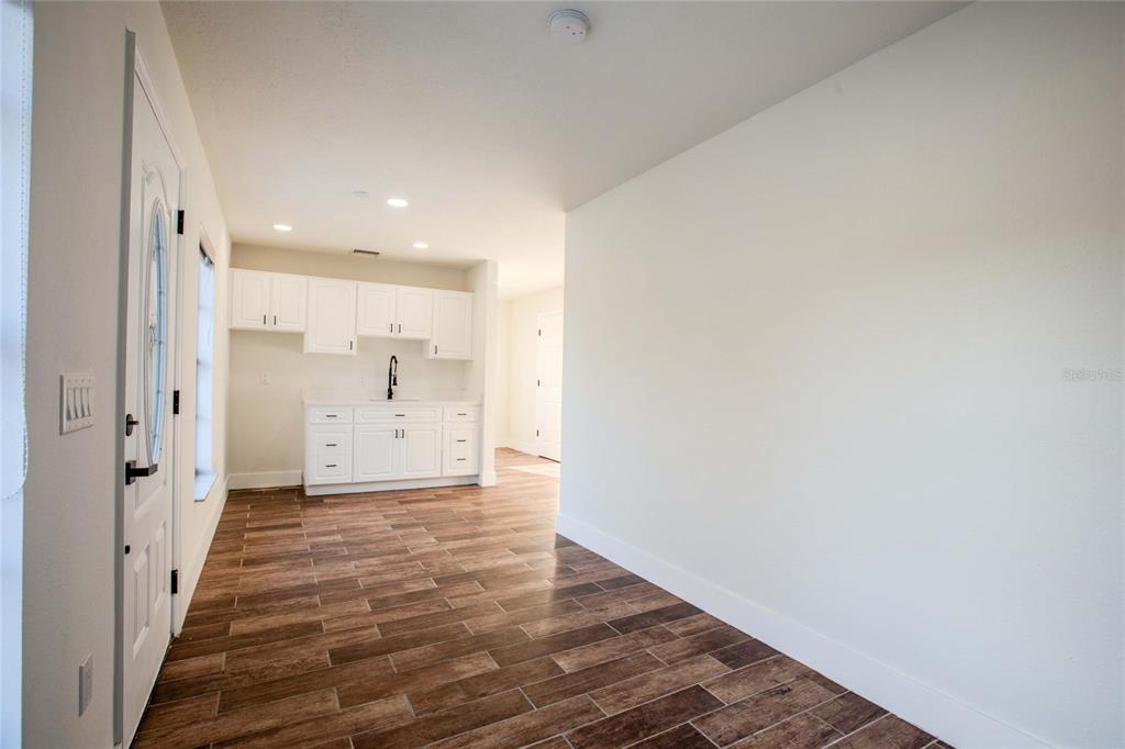 3324 Haystack Road Wesley Chapel, FL 33543 - Photo 63 of 91 a view of a hallway with wooden floor and a bathroom