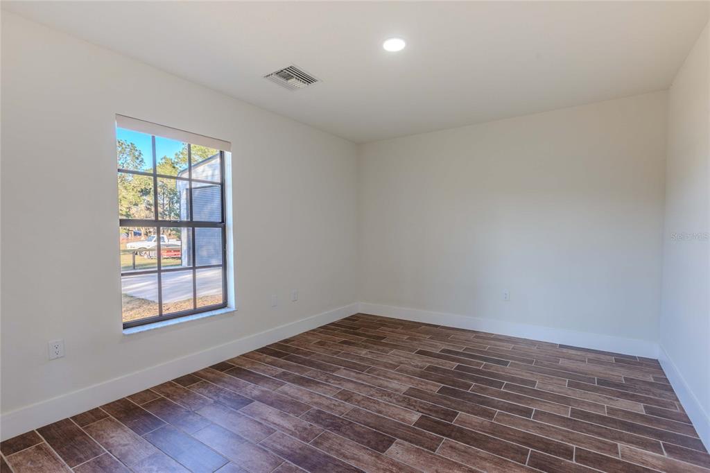 3324 Haystack Road Wesley Chapel, FL 33543 - Photo 64 of 91 wooden floor in an empty room with a window