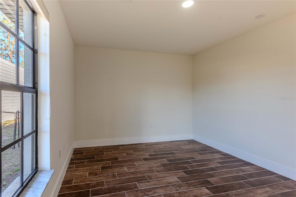 3324 Haystack Road Wesley Chapel, FL 33543 - Photo 65 of 91 a view of an empty room and wooden floor and a window