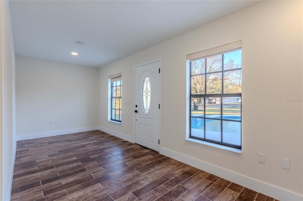 3324 Haystack Road Wesley Chapel, FL 33543 - Photo 67 of 91 wooden floor in an empty room with a window