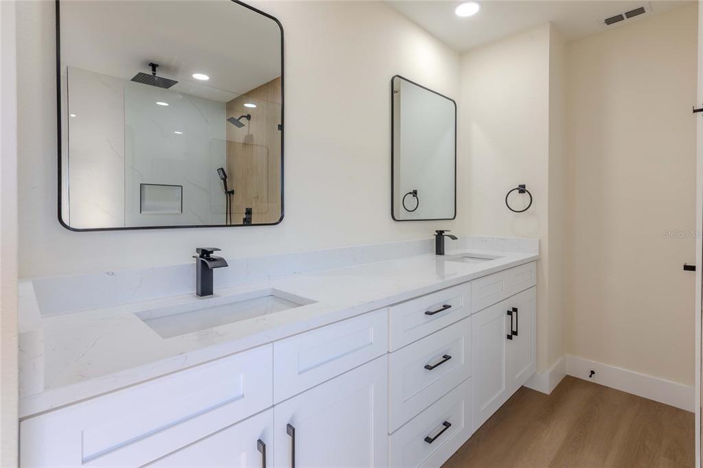 3324 Haystack Road Wesley Chapel, FL 33543 - Photo 7 of 91 a bathroom with double vanity sink two mirror and vanity