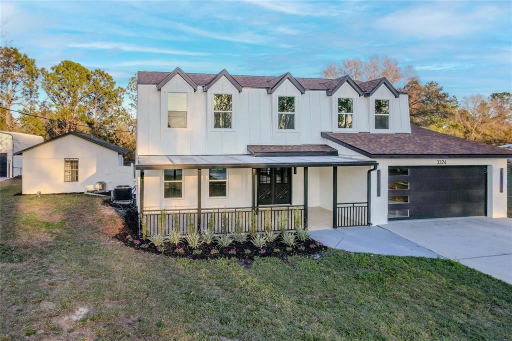 3324 Haystack Road Wesley Chapel, FL 33543 - Photo 85 of 91 a front view of a house with garden