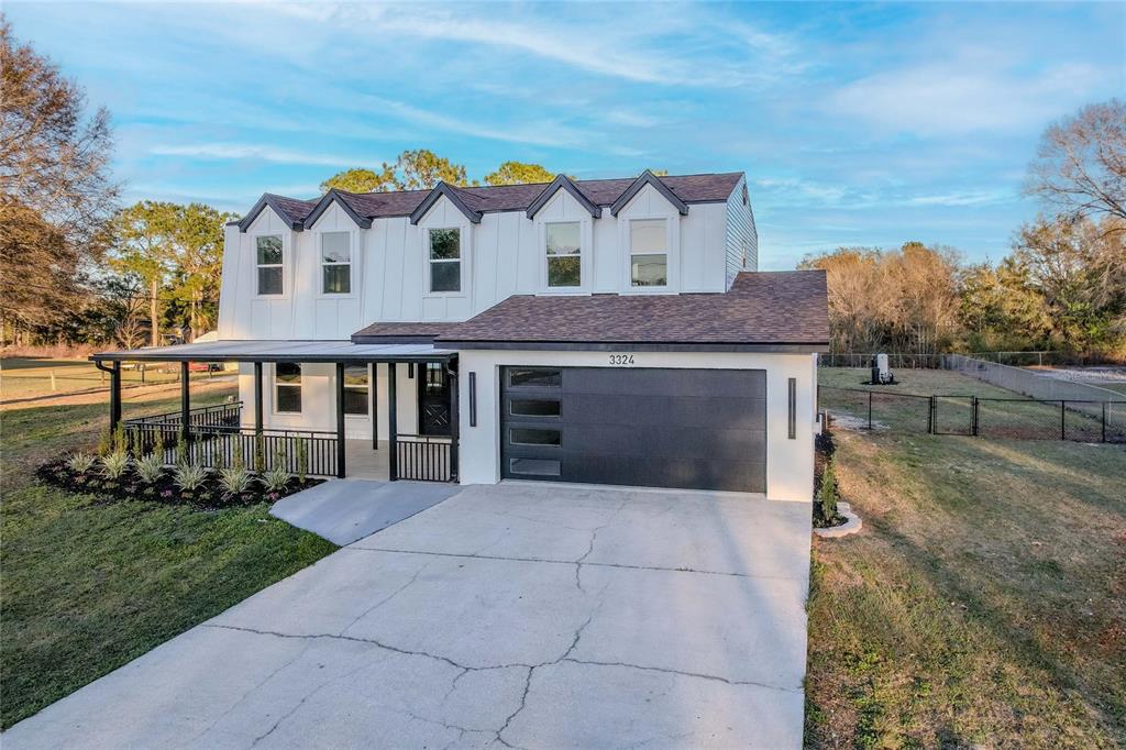 3324 Haystack Road Wesley Chapel, FL 33543 - Photo 86 of 91 a front view of a house with a yard and garage