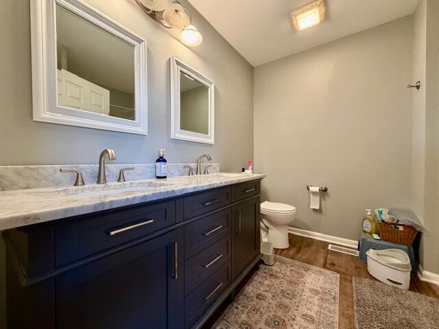 11610 Broadway Crown Point, IN 46307 - Photo 8 of 14 a bathroom with a toilet sink and mirror