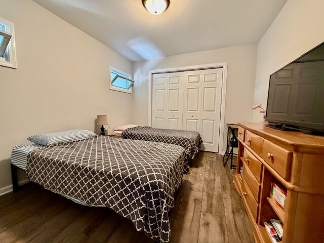 11610 Broadway Crown Point, IN 46307 - Photo 9 of 14 a bedroom with a bed and wooden floor