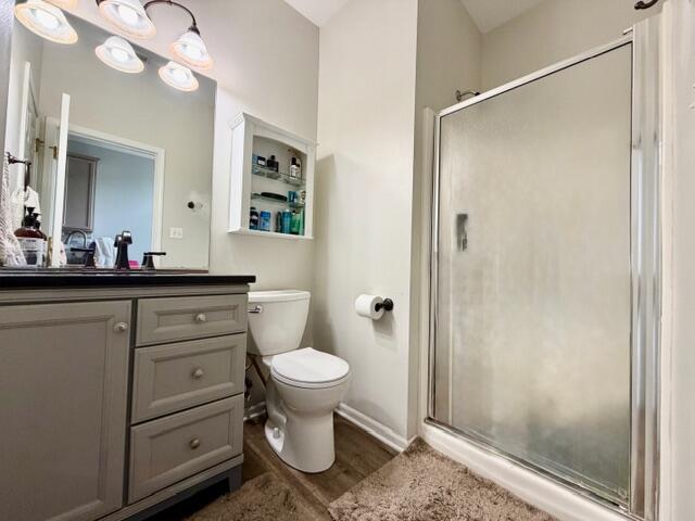 11610 Broadway Crown Point, IN 46307 - Photo 10 of 14 a bathroom with a sink toilet a mirror a vanity and shower