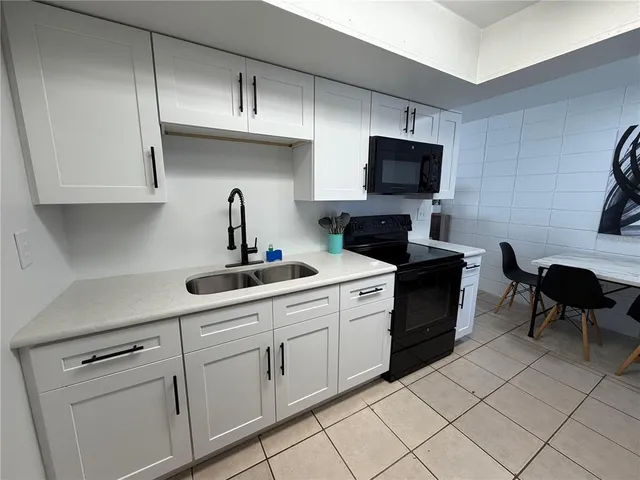 a kitchen with cabinets stainless steel appliances and a sink