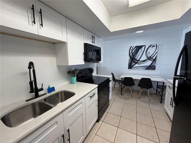 a kitchen with a sink and a stove top oven