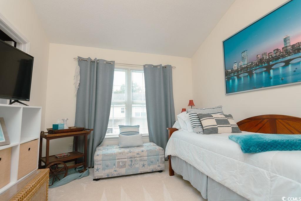 821 Sheridan Road, Unit 821 Myrtle Beach, SC 29579 - Photo 25 of 40 Carpeted bedroom featuring vaulted ceiling