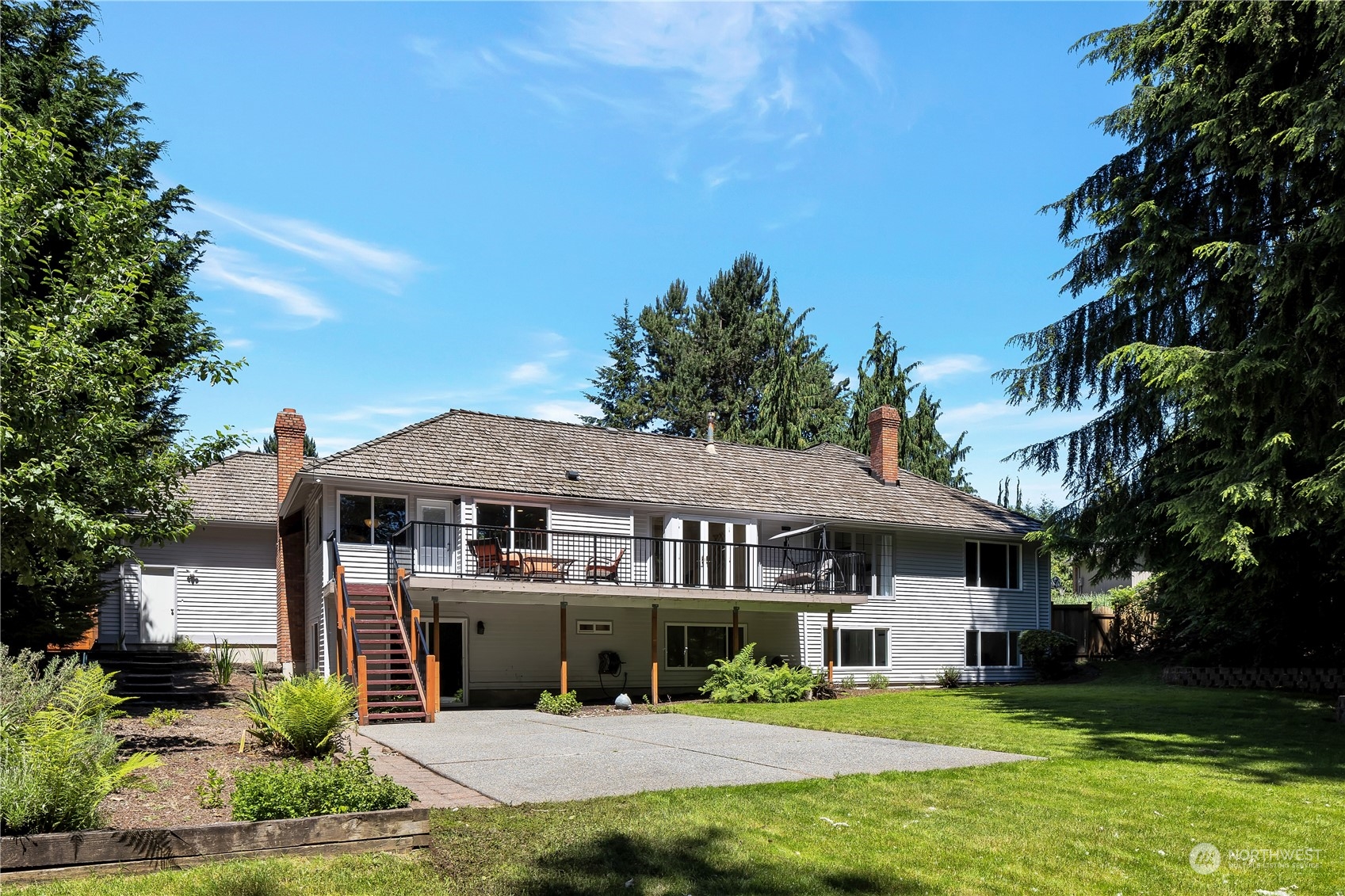 2926 184th Place Southeast Bothell, WA 98012 - Photo 22 of 24 a front view of a house with a garden and trees