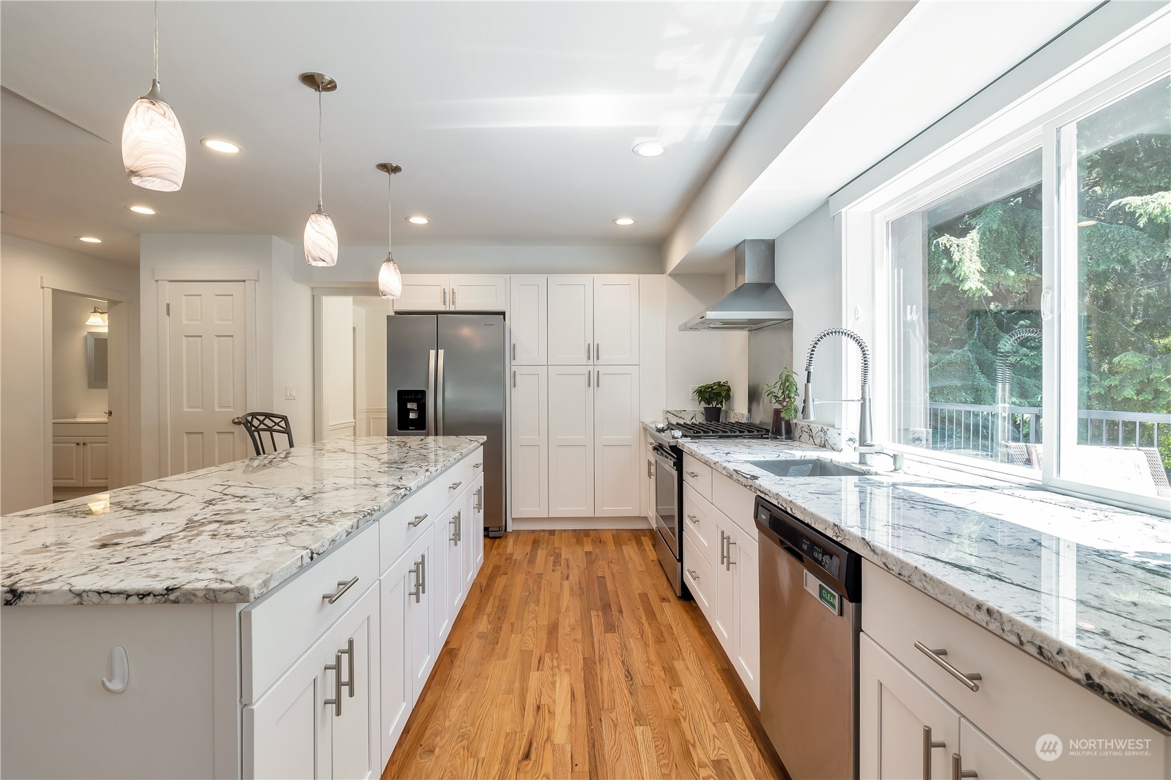 2926 184th Place Southeast Bothell, WA 98012 - Photo 4 of 24 a large kitchen with granite countertop a large counter top a sink stainless steel appliances and cabinets