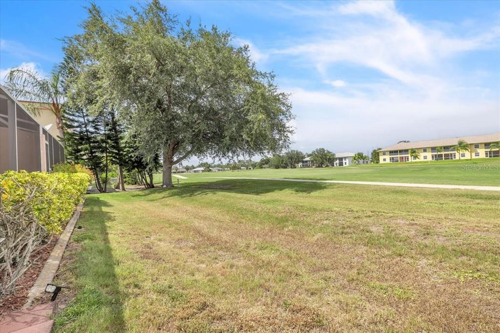 1260 Rio De Janeiro Avenue, Unit 102 Punta Gorda, FL 33983 - Photo 37 of 46 a view of a lake with a big yard