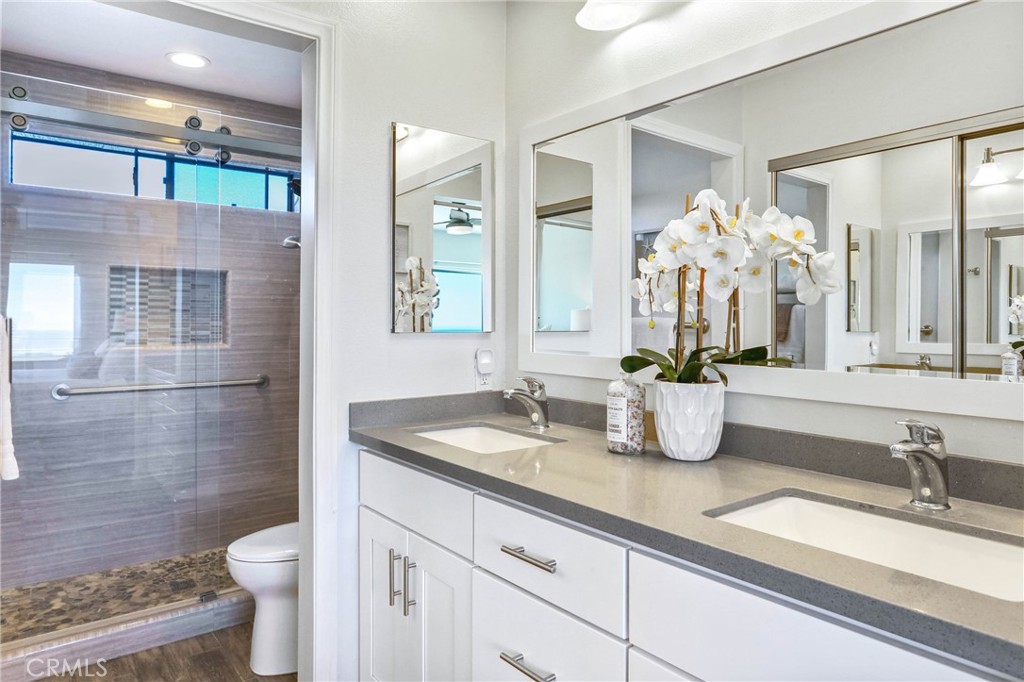 33885 Manta Court Dana Point, CA 92629 - Photo 12 of 34 a bathroom with a granite countertop sink a toilet and a mirror