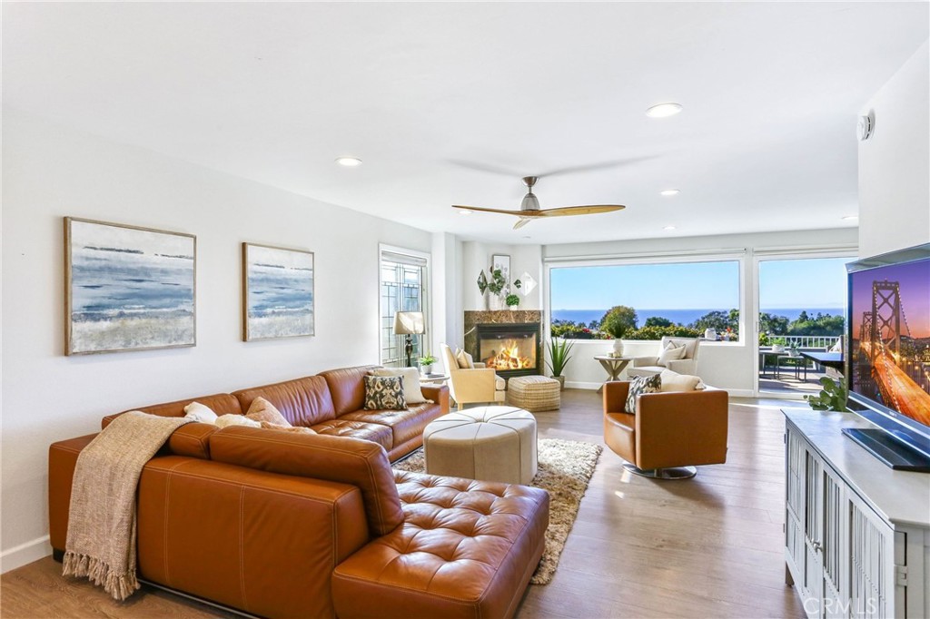 33885 Manta Court Dana Point, CA 92629 - Photo 2 of 34 a living room with furniture a large window and a flat screen tv