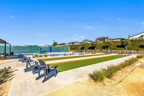 a view of swimming pool with outdoor seating and yard in the back
