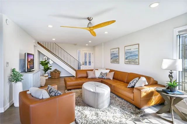 a living room with furniture ceiling fan and a rug