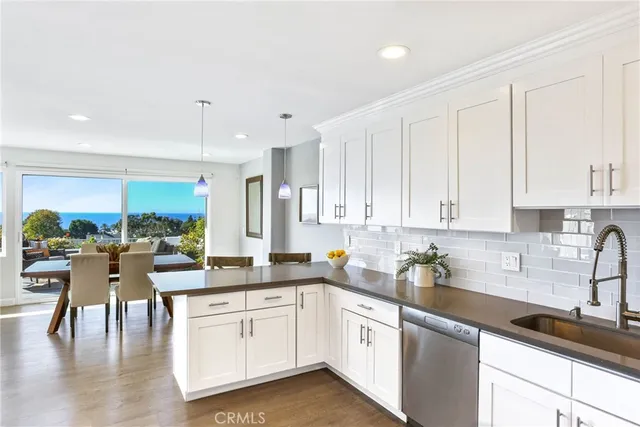 a kitchen with a white cabinets sink and white appliances