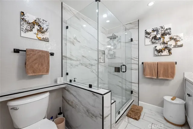 a bathroom with a sink mirror vanity and toilet