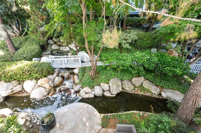 a view of a backyard with plants and a patio