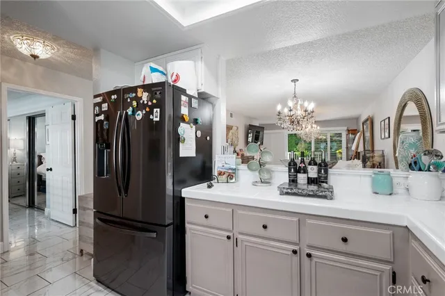 a kitchen with refrigerator and cabinets