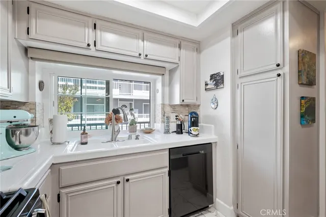 a kitchen with stainless steel appliances a sink stove and refrigerator