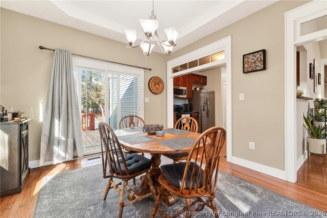 124 Riviera Lane Sanford, NC 27332 - Photo 11 of 45 a dining room with furniture a chandelier and wooden floor