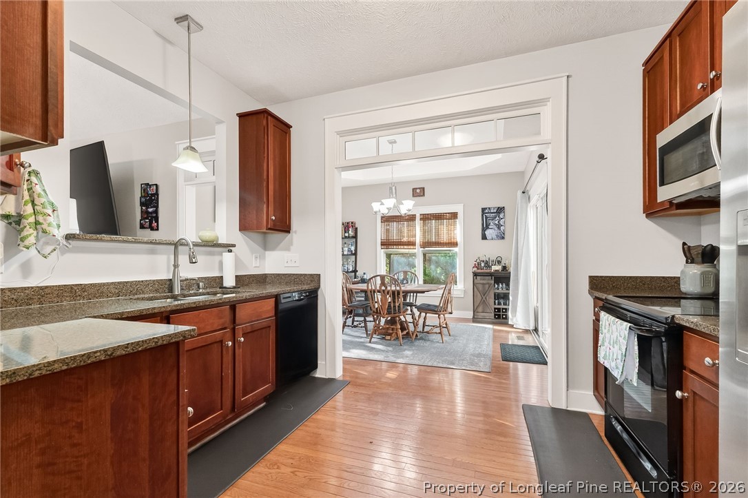 124 Riviera Lane Sanford, NC 27332 - Photo 16 of 45 a large kitchen with stainless steel appliances granite countertop a stove a sink and a microwave