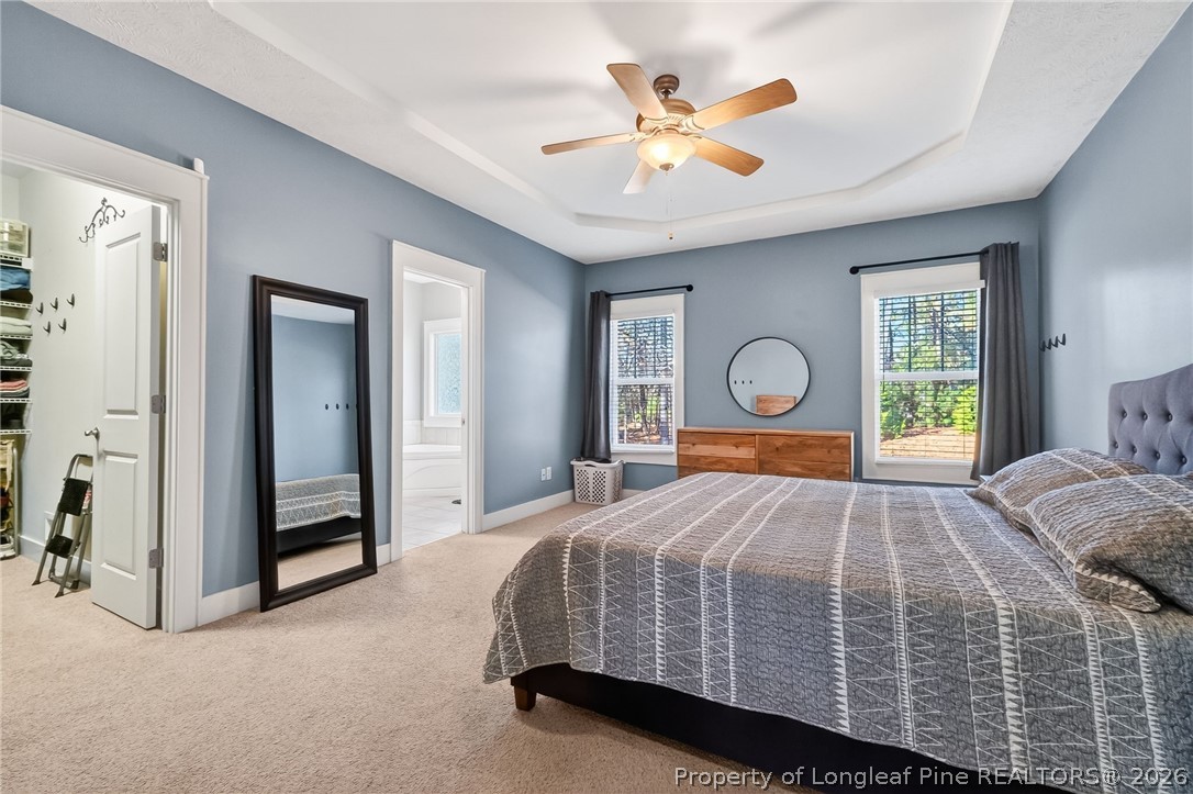 124 Riviera Lane Sanford, NC 27332 - Photo 17 of 45 a bedroom with a bed and a chandelier