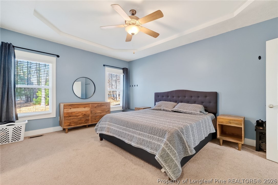 124 Riviera Lane Sanford, NC 27332 - Photo 18 of 45 a bed room with a bed and a chandelier