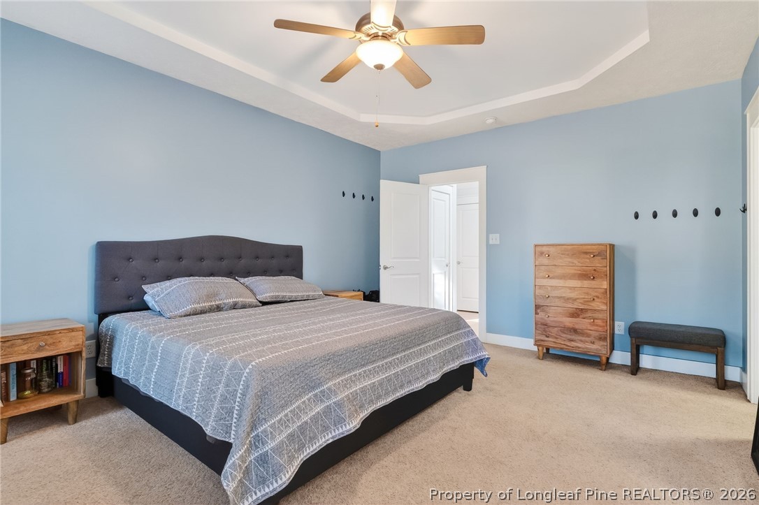 124 Riviera Lane Sanford, NC 27332 - Photo 20 of 45 a bedroom with a bed and a chandelier