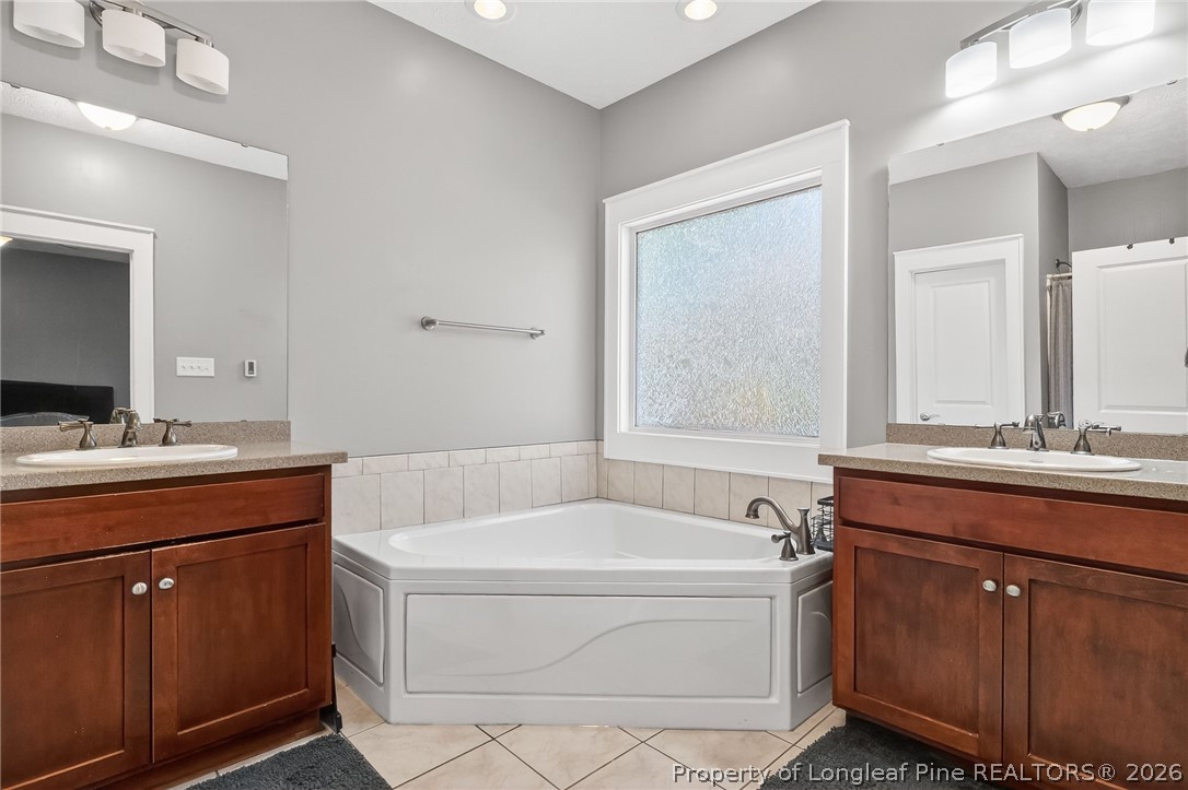 124 Riviera Lane Sanford, NC 27332 - Photo 21 of 45 a bathroom with a tub sink and mirror