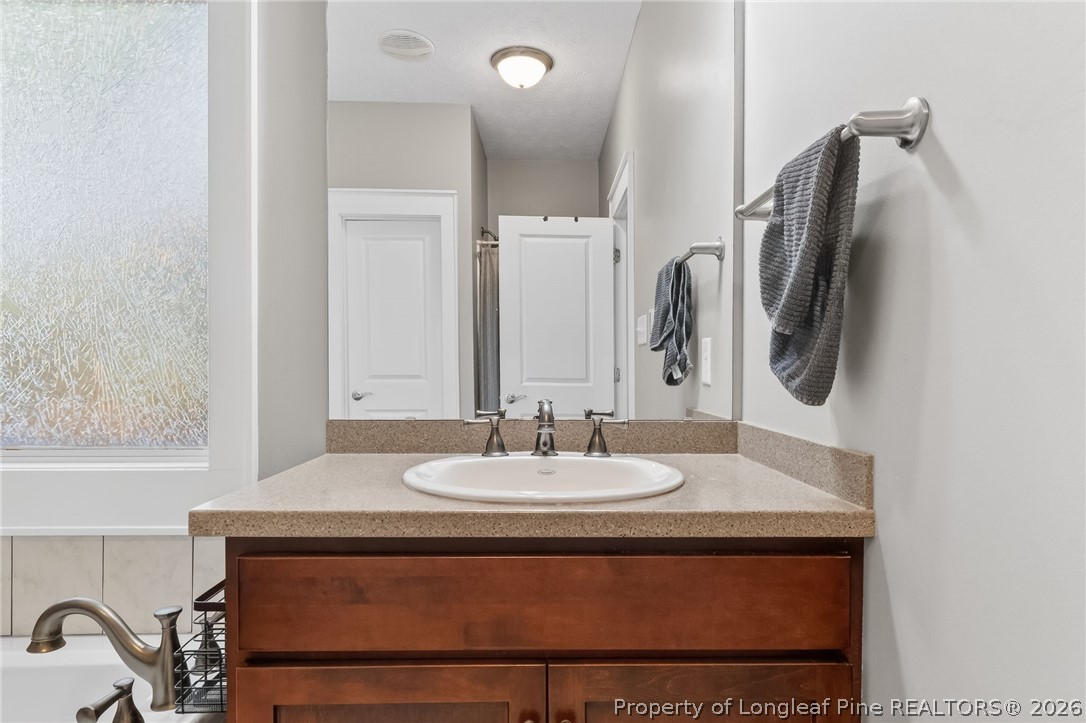 124 Riviera Lane Sanford, NC 27332 - Photo 23 of 45 a bathroom with a sink and mirror