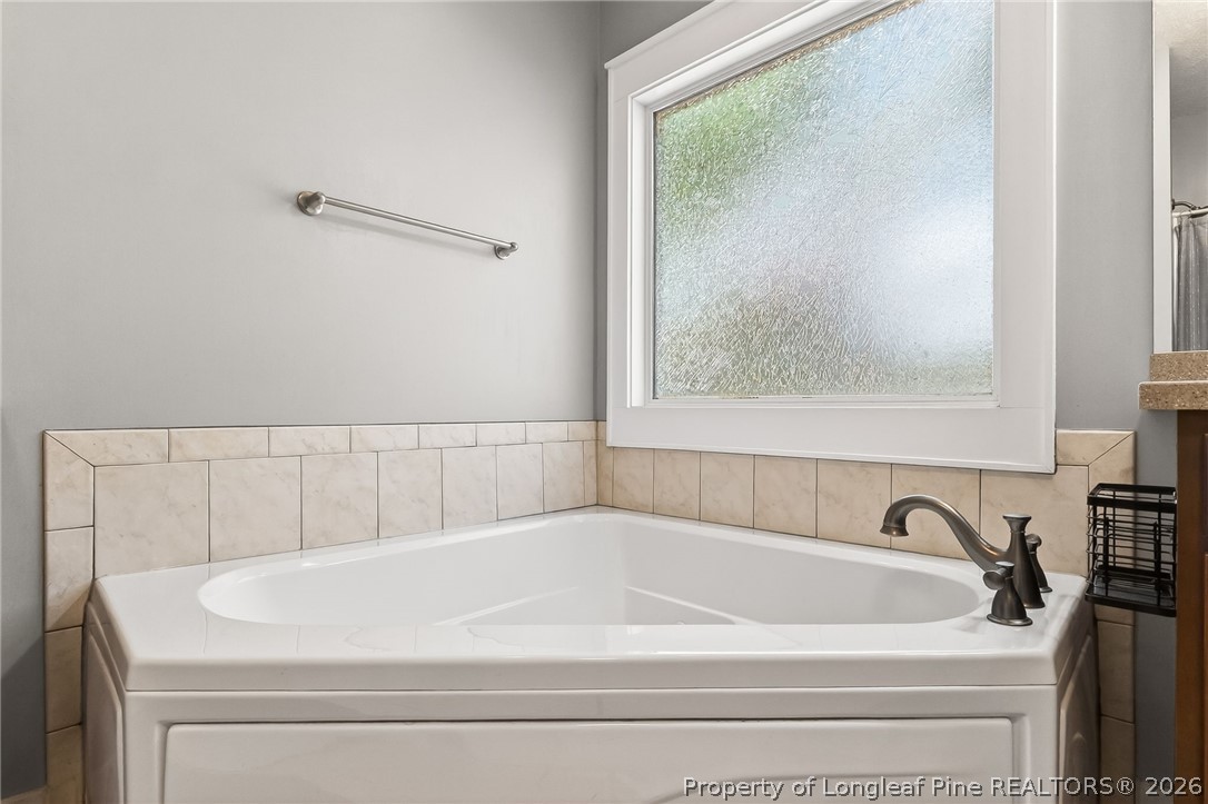 124 Riviera Lane Sanford, NC 27332 - Photo 24 of 45 a white bath tub sitting next to a window