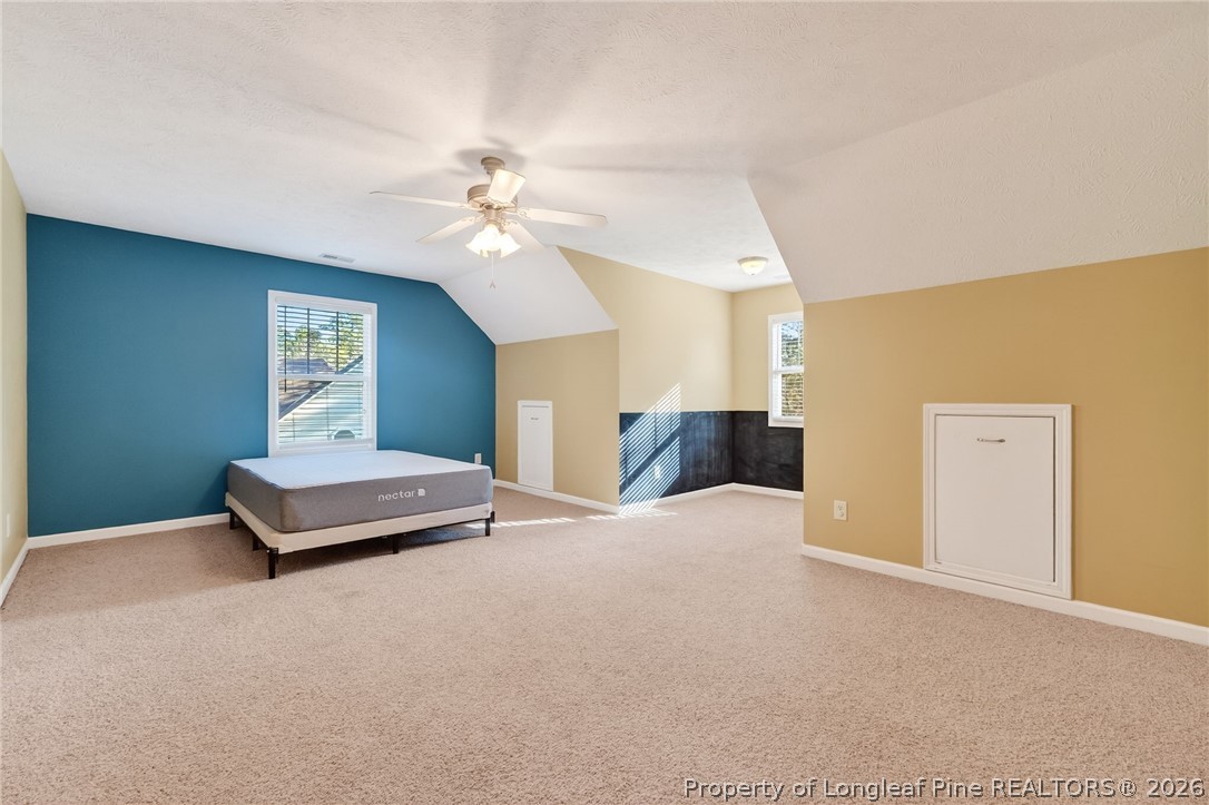 124 Riviera Lane Sanford, NC 27332 - Photo 26 of 45 a spacious bedroom with a bed and a chandelier
