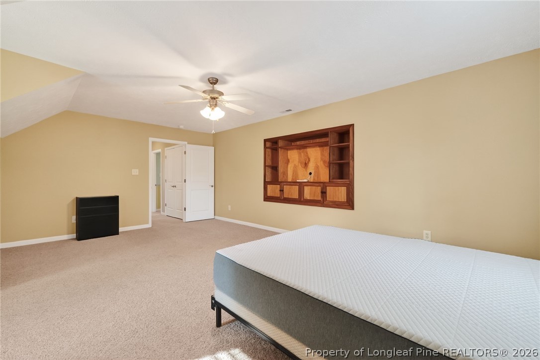 124 Riviera Lane Sanford, NC 27332 - Photo 28 of 45 a room with a bed and a ceiling fan