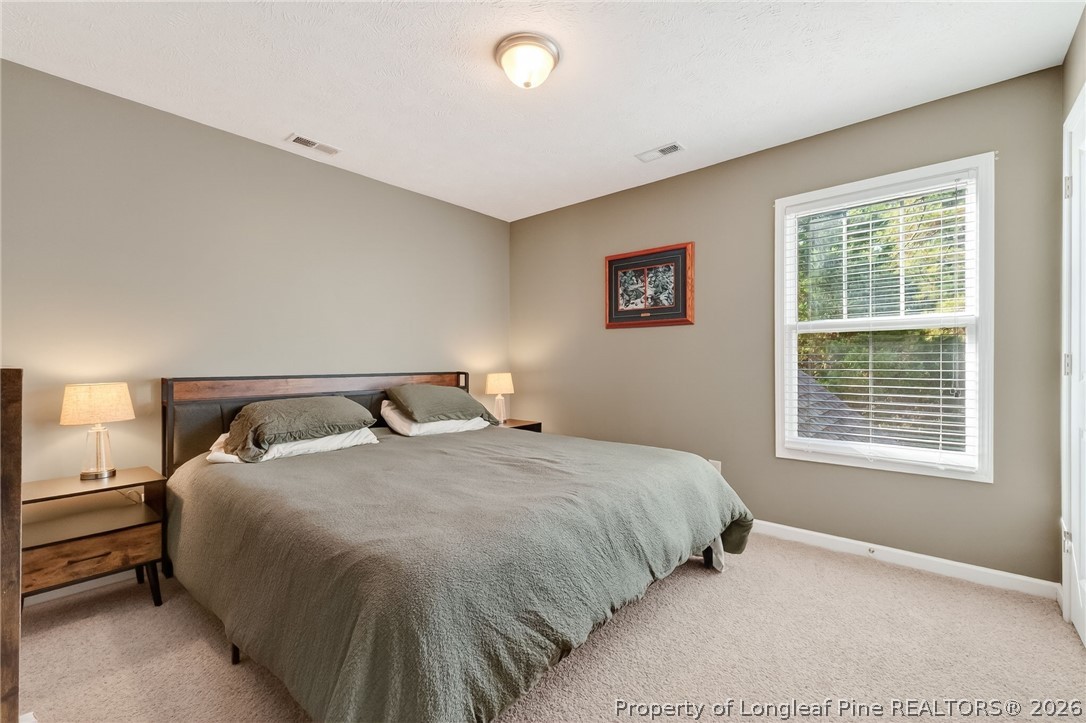 124 Riviera Lane Sanford, NC 27332 - Photo 32 of 45 a bedroom with a bed and a window