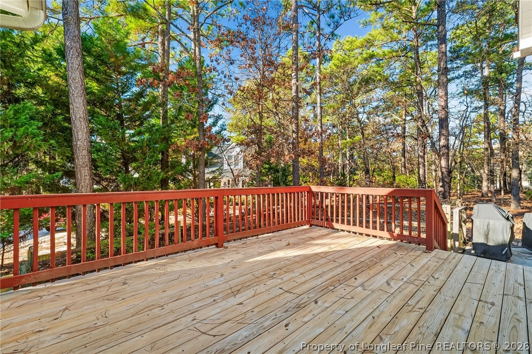 124 Riviera Lane Sanford, NC 27332 - Photo 37 of 45 a balcony with wooden floor and trees