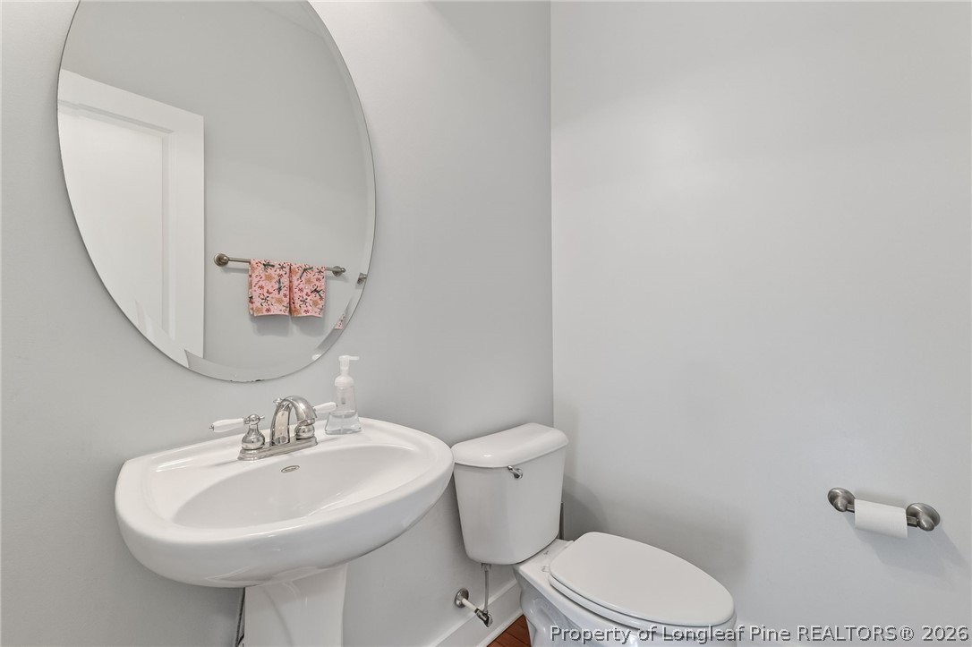 124 Riviera Lane Sanford, NC 27332 - Photo 9 of 45 a bathroom with a sink a mirror and a toilet