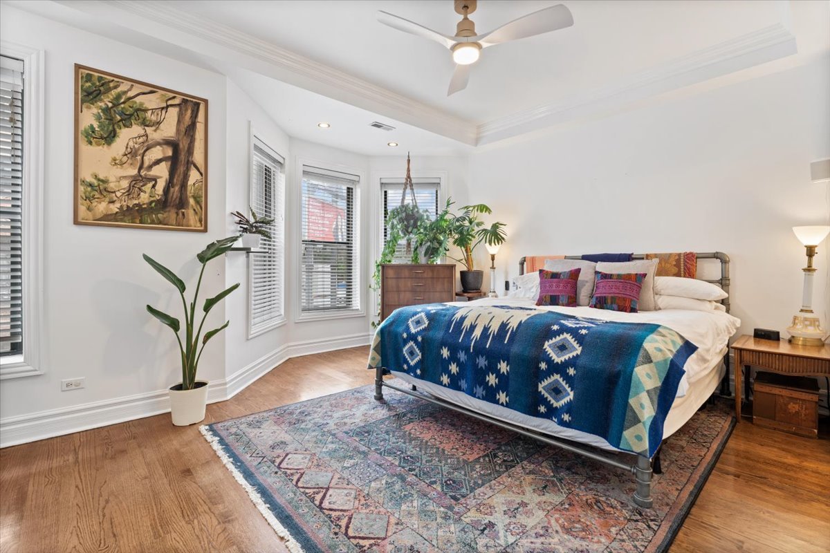 1048 West Lawrence Avenue, Unit 2 Chicago, IL 60640 - Photo 9 of 16 a bedroom with a bed a dresser and potted plants