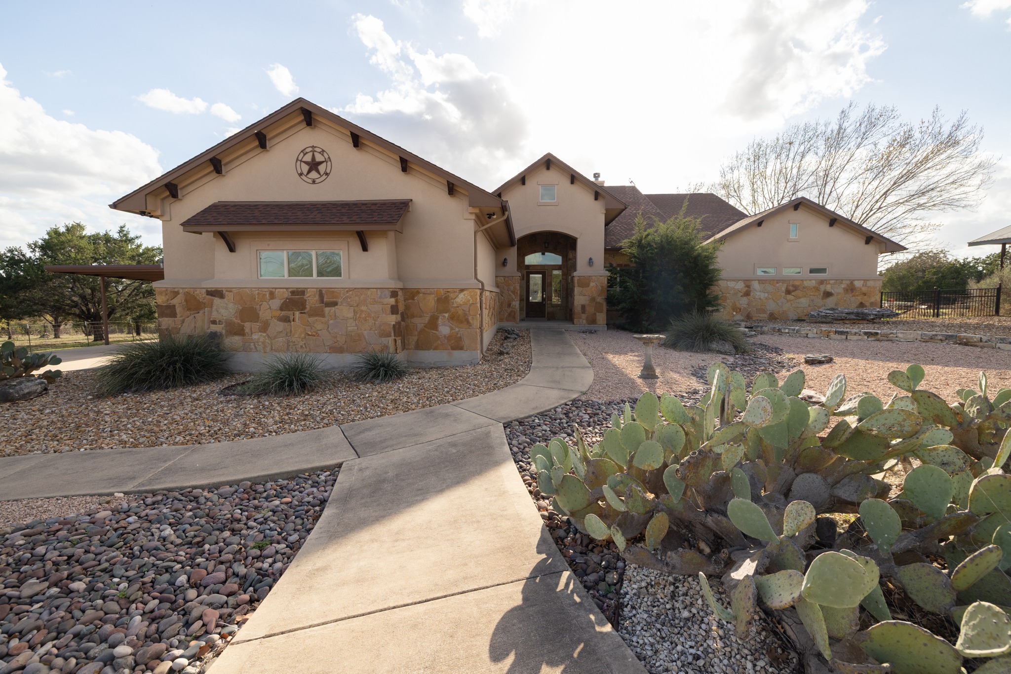 Mediterranean / spanish house featuring stone siding and stucco siding