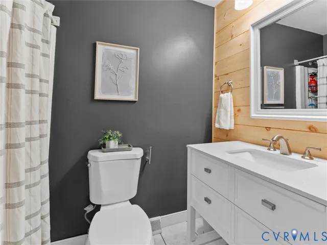 a spacious bedroom with a bed and a chandelier