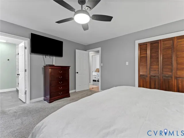 a bathroom with a granite countertop sink a toilet a mirror and shower