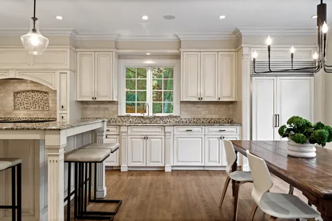 a kitchen with stainless steel appliances granite countertop a stove a sink dishwasher a microwave oven and cabinets with wooden floor