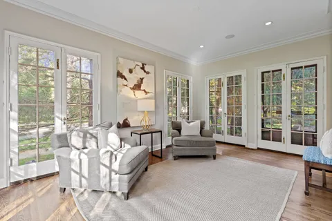 a living room with furniture and large windows