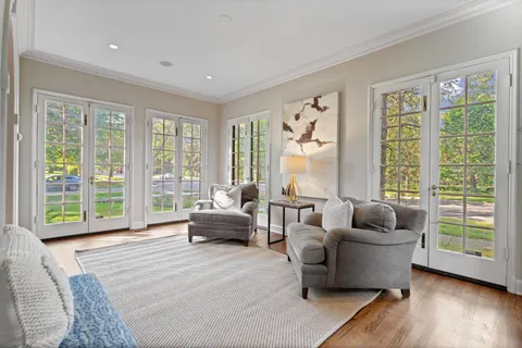 a living room with furniture and a large window with outer view