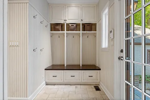 a view of a hallway with wooden floor and cabinet
