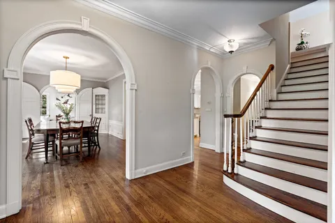 a view of a livingroom kitchen and hall with wooden floor