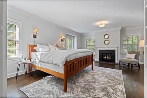 a bedroom with a bed and a fireplace